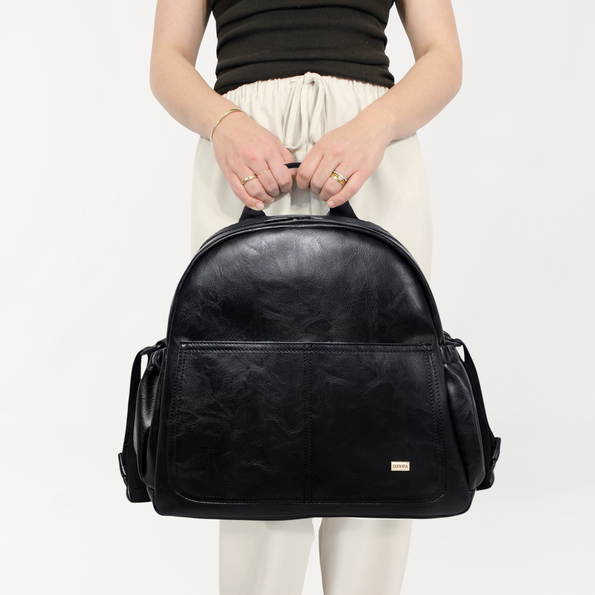 Remmii Emerson Nappy Backpack in Black, Front View With Person