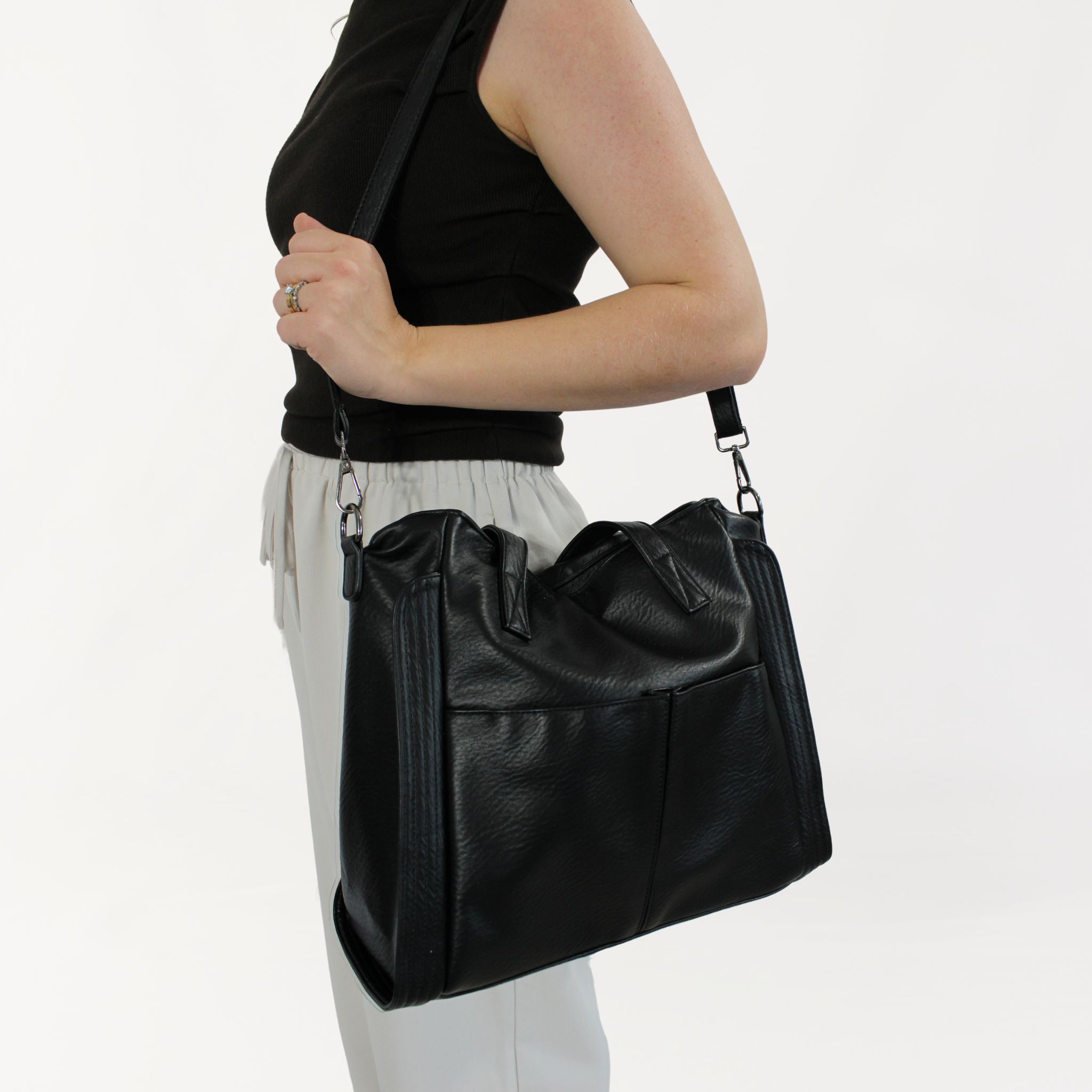 Remmii Harper Baby Tote in Black, Being Worn Over One Shoulder On A Angle