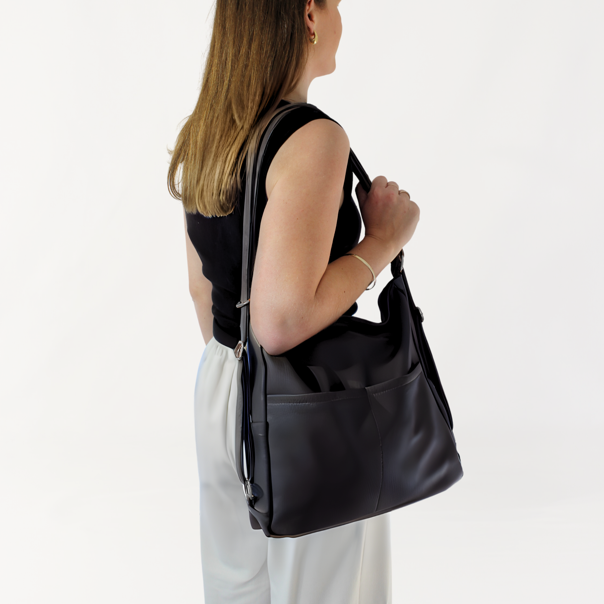 Remmii Noah Baby Tote in Black, Being Worn Over One Shoulder