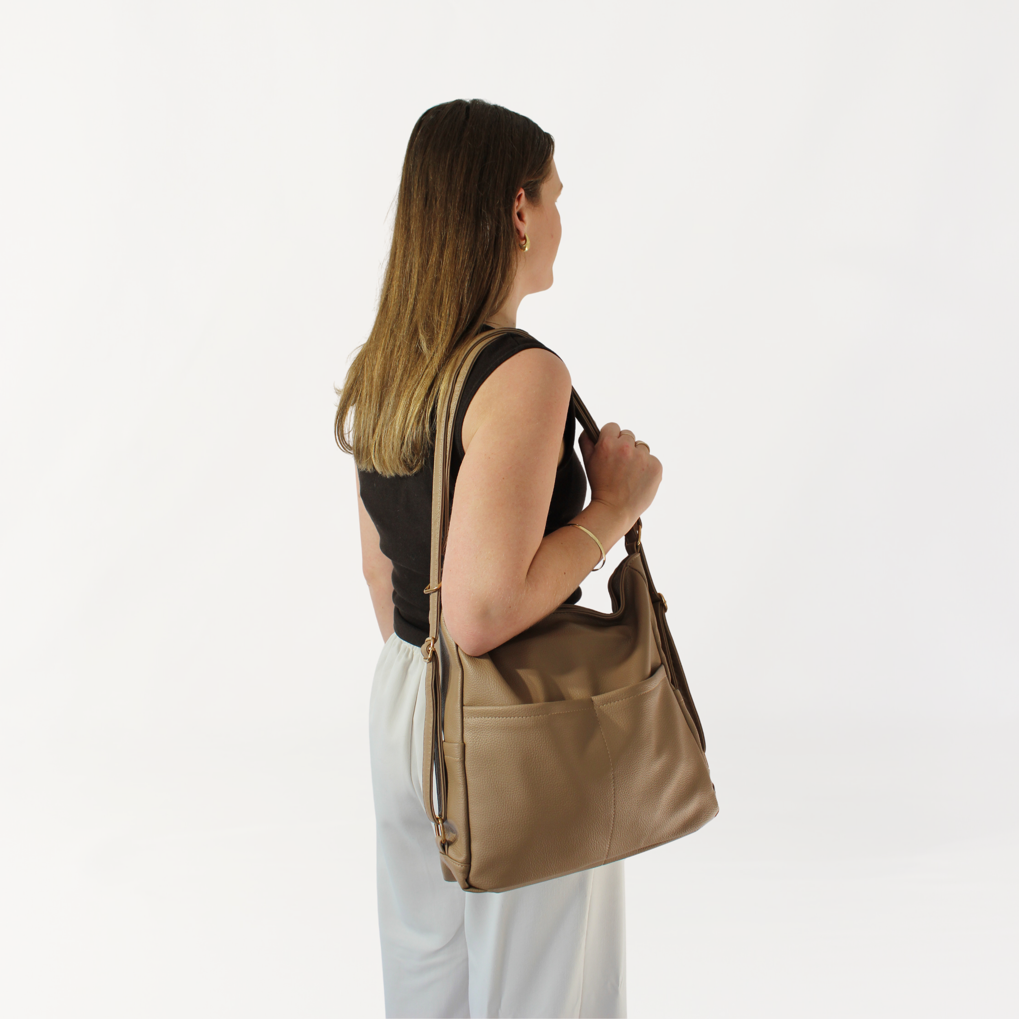 Remmii Noah Baby Tote in Tan, Being Worn Over One Shoulder
