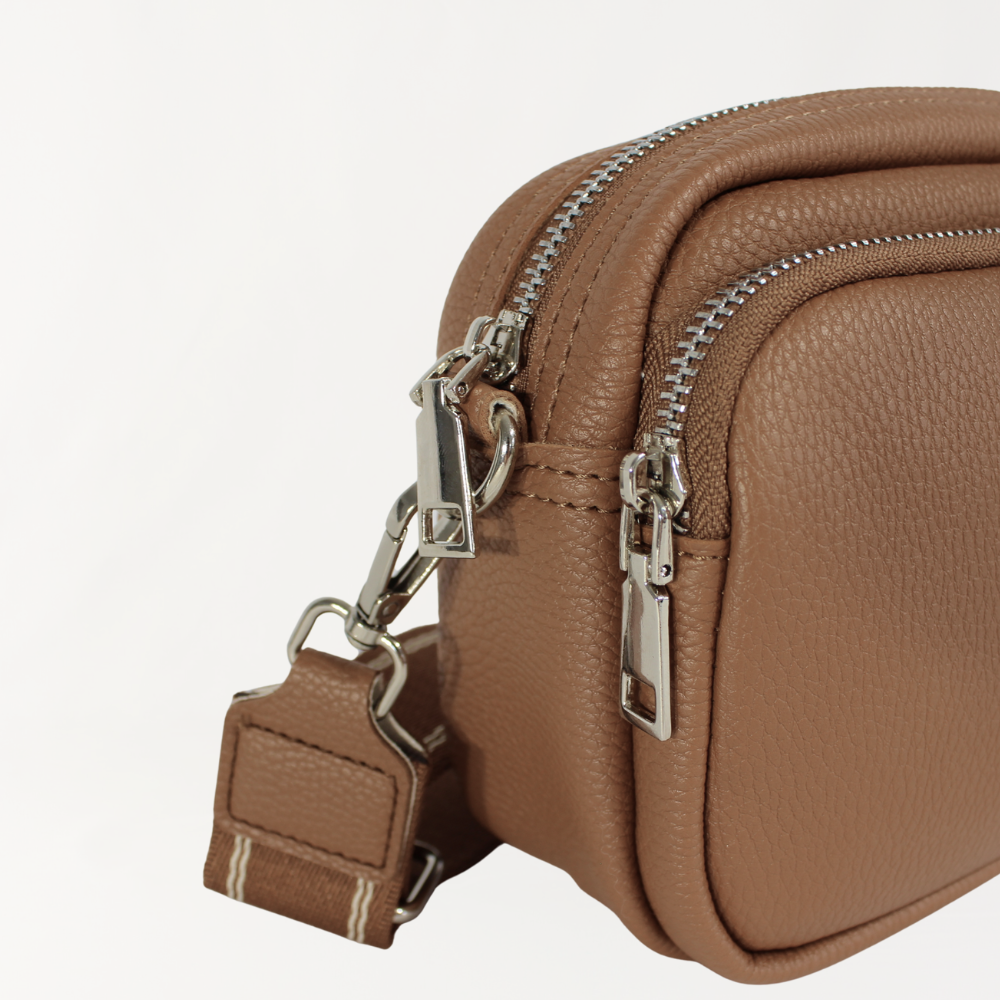 Remmii Riley Crossbody Baby Bag in Almond, Angle View Close Up