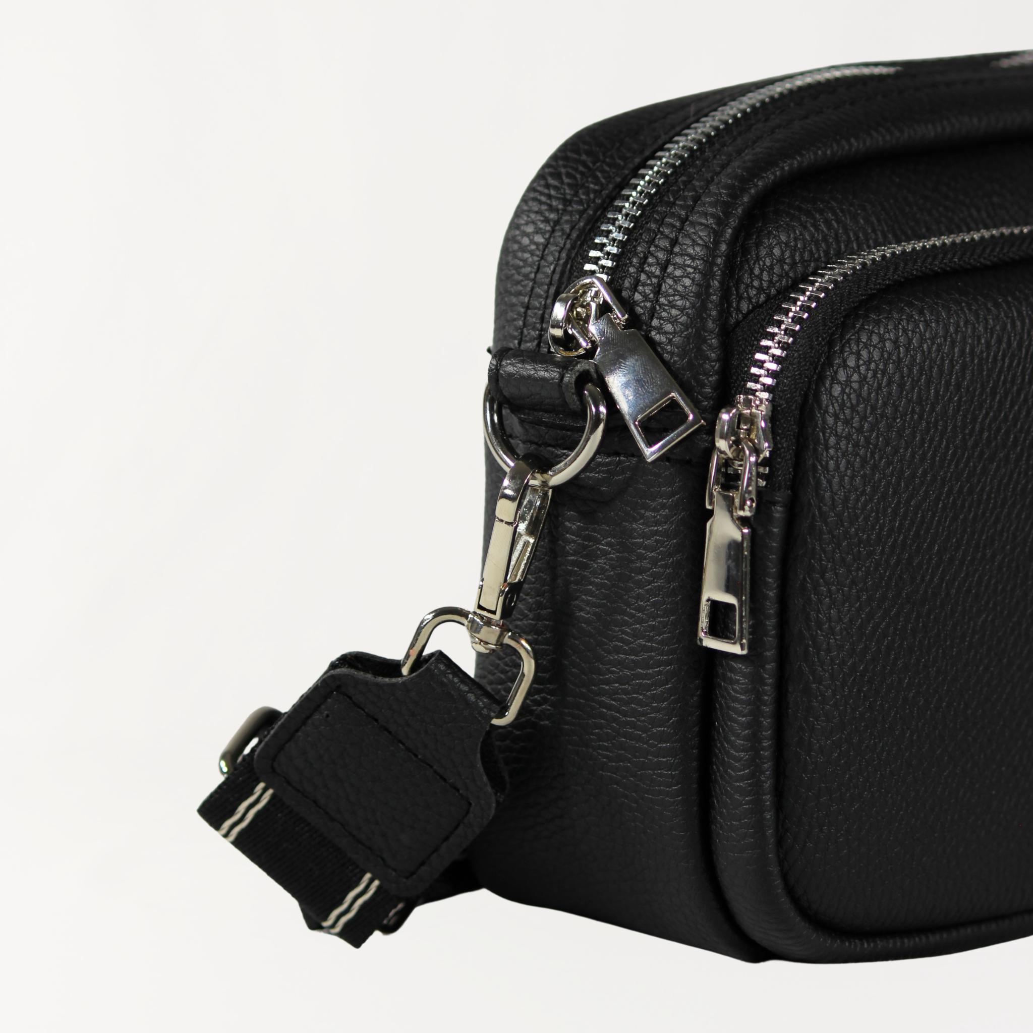 Remmii Riley Crossbody Baby Bag in Black, Close Up View