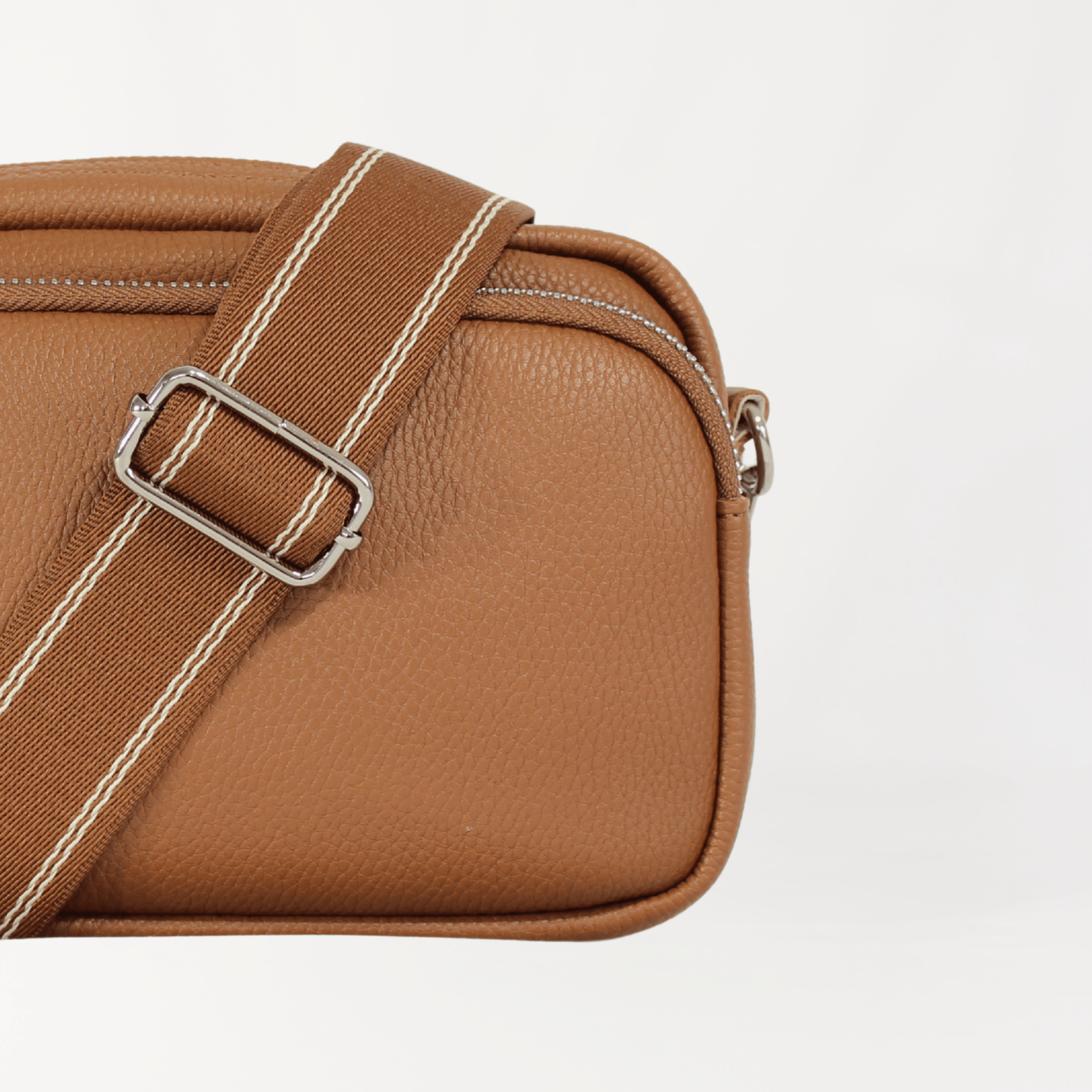 Remmii Riley Crossbody Baby Bag in Caramel, Front View Close Up