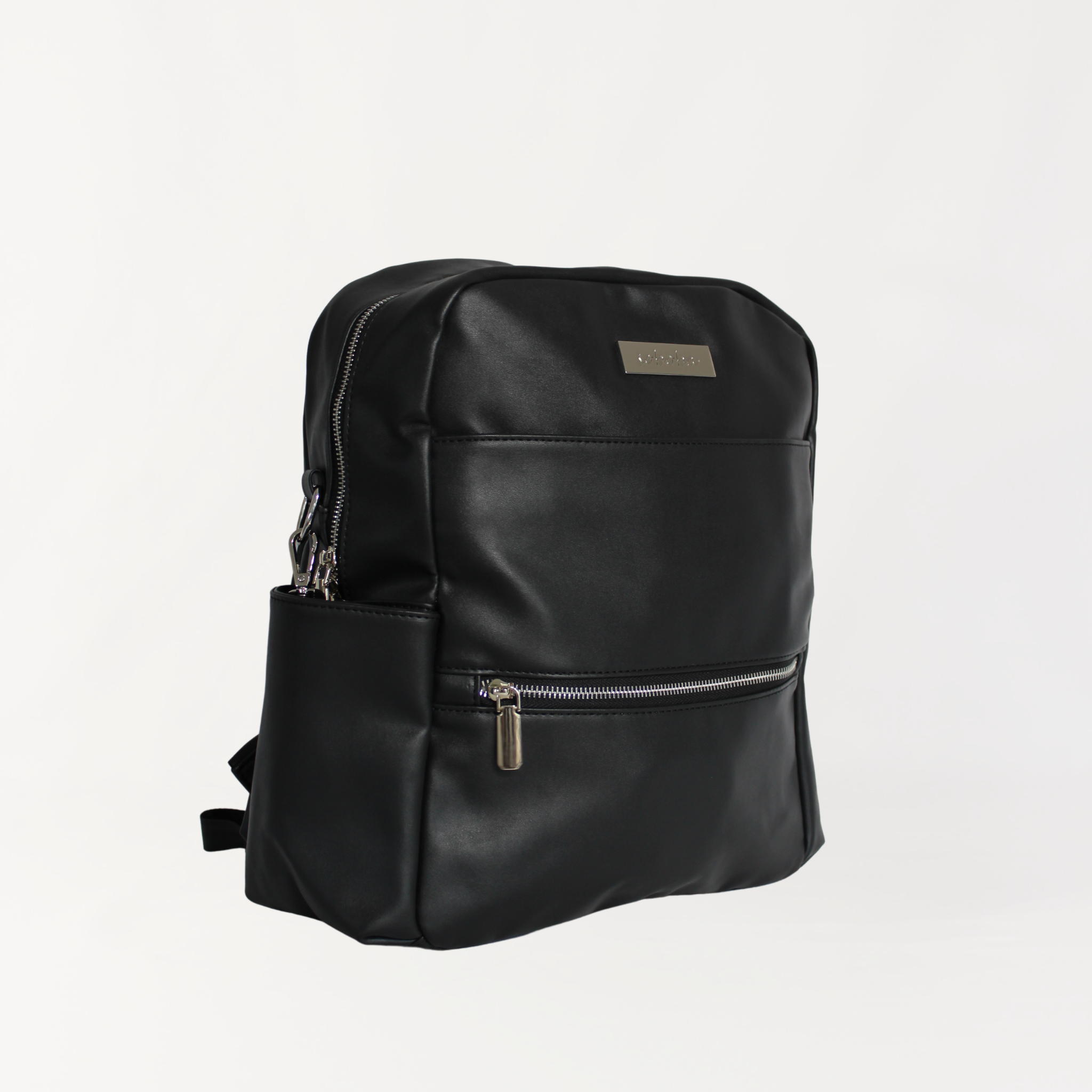 Remmii Carter Nappy Backpack in Black, Angle View and Top Handle is Hidden