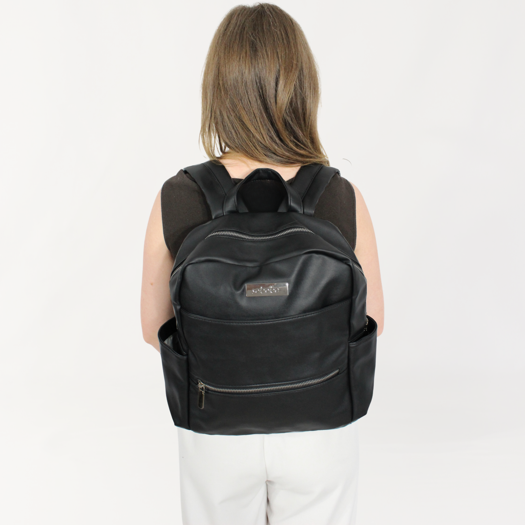 Remmii Carter Nappy Backpack in Black, Front View Being Worn By Mum