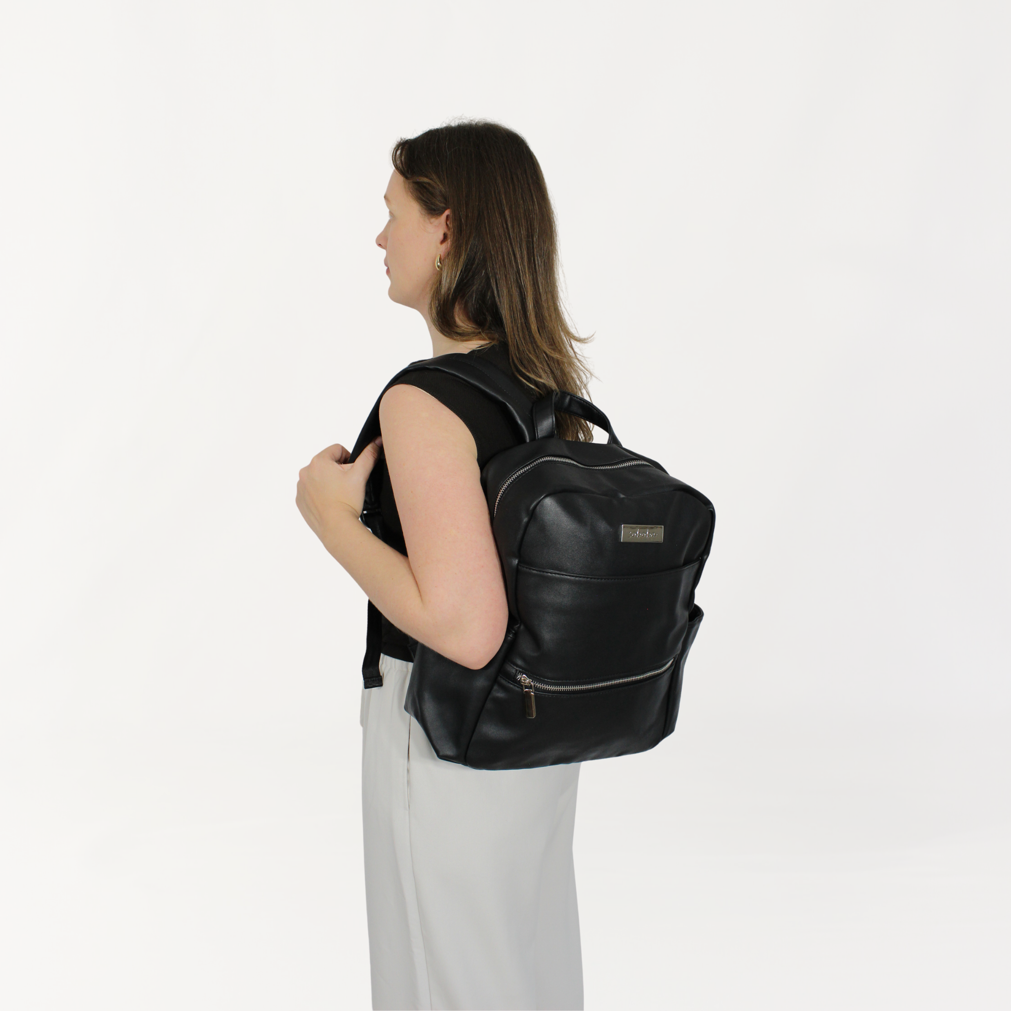 Remmii Carter Nappy Backpack in Black, Being Worn Over One Shoulder