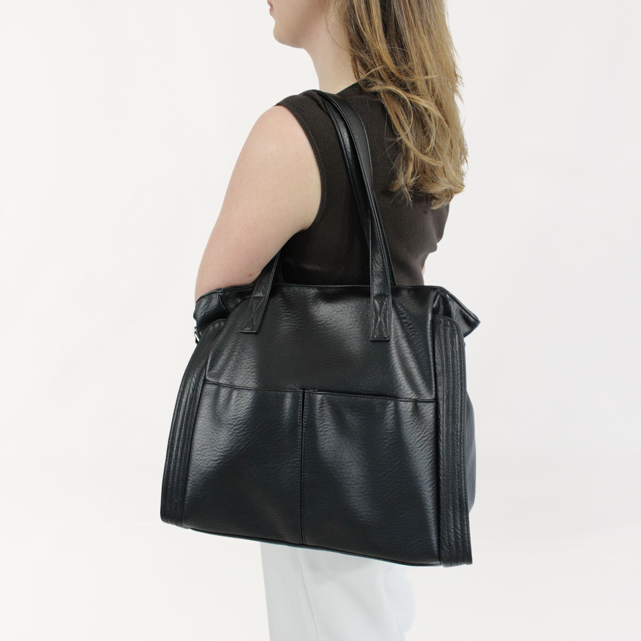 Remmii Harper Baby Tote in Black, Being Worn Over One Shoulder With Short Strap