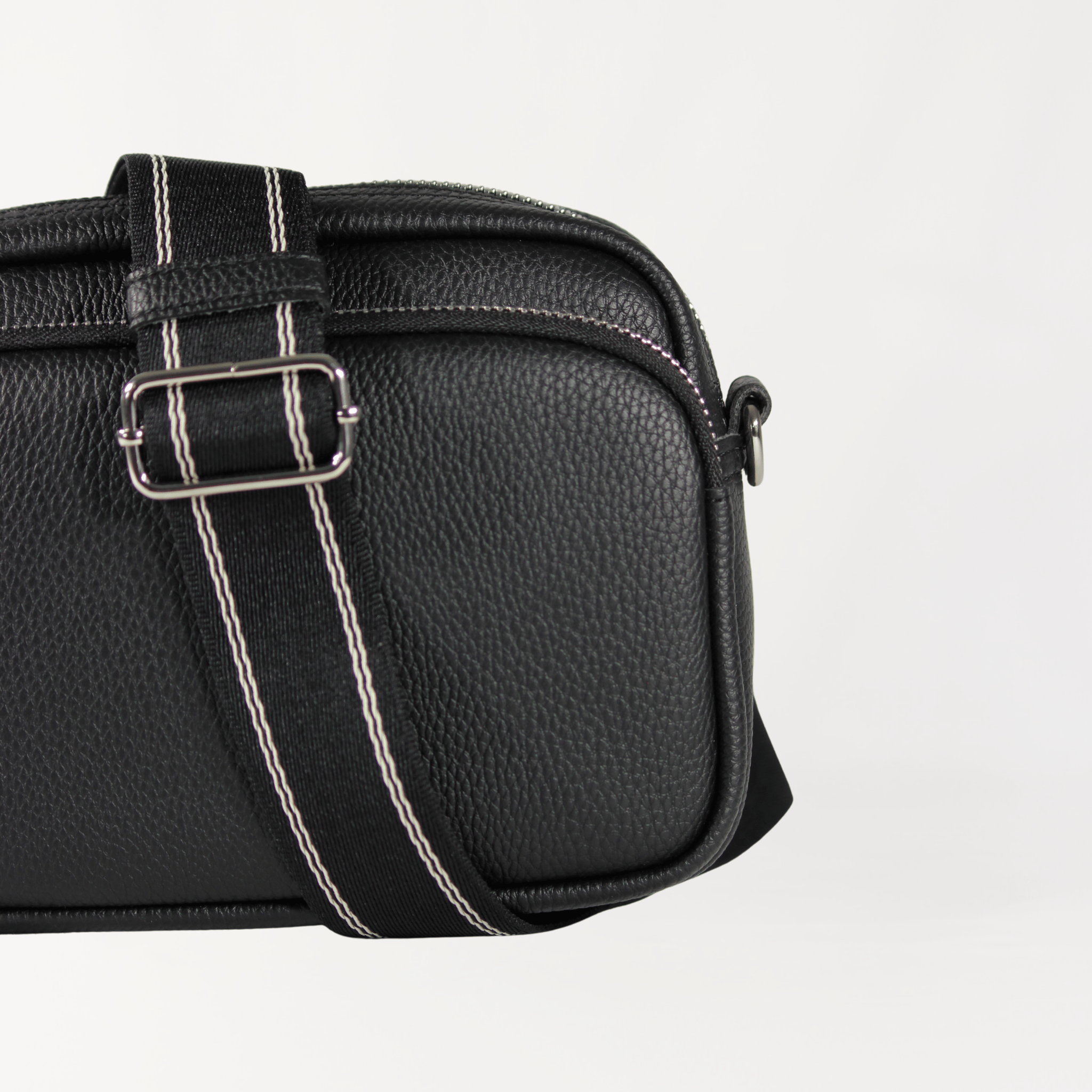 Remmii Riley Crossbody Baby Bag in Black, Close Up View Of Strap