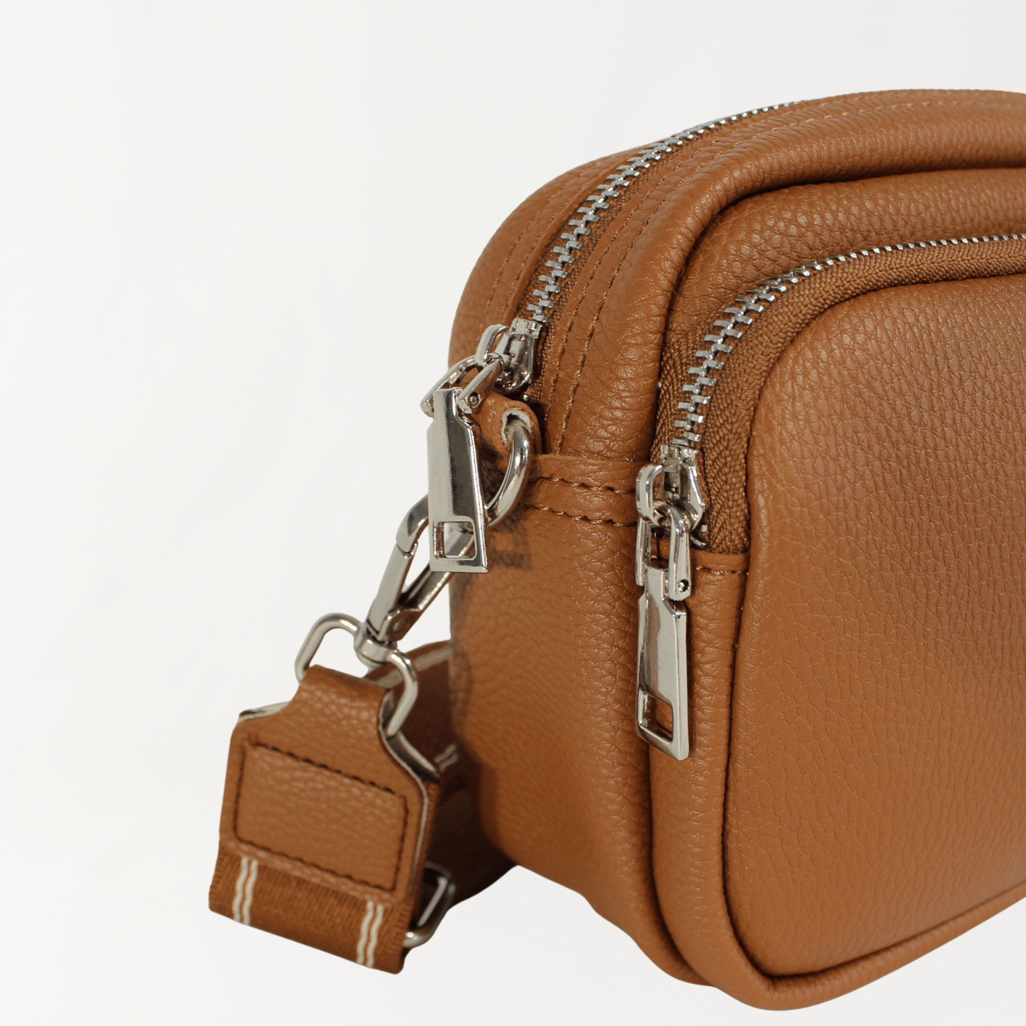 Remmii Riley Crossbody Baby Bag in Caramel, Angle View Close Up