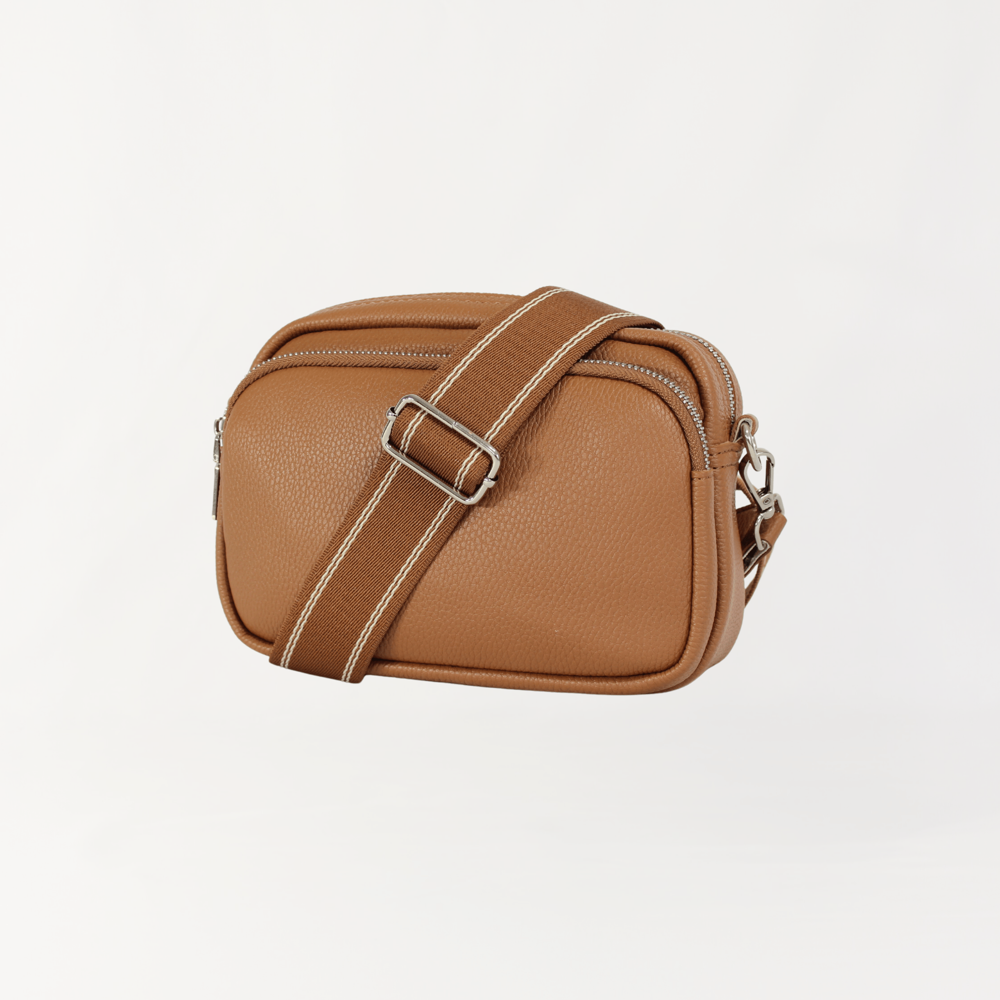 Remmii Riley Crossbody Baby Bag in Caramel, Front View Strap Over Bag Angle
